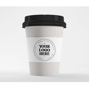 May include: A disposable coffee cup with a black lid. The cup has a white paper sleeve with the text "YOUR LOGO HERE" in a circular design. The cup is light gray.