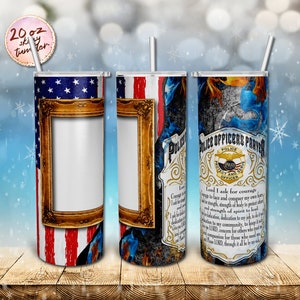 May include: A 20 ounce stainless steel tumbler with a design featuring an American flag, a gold picture frame, and a blue and black flame design. The tumbler also features a police officer's prayer with the text "Lord I ask for courage to face and conquer my own fears. I ask for strength of body to protect others and strength of spirit to lead. I ask for dedication to my community, to keep it safe. Give me compassion for those who need me and please LORD, through it all be my shield."