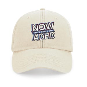 May include: A beige baseball cap with an embroidered design that says "NOW THAT'S WHAT I CALL ADHD" in blue, pink, and white.