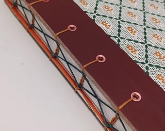 A vintage 1979 Readers Digest patterned hardcover transformed into a handmade journal with a striking mid-century illustration