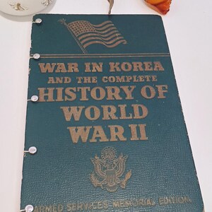 May include: A vintage book titled "War in Korea and the Complete History of World War II." The cover is dark teal with gold lettering and an American flag graphic. The book is an Armed Services Memorial Edition.