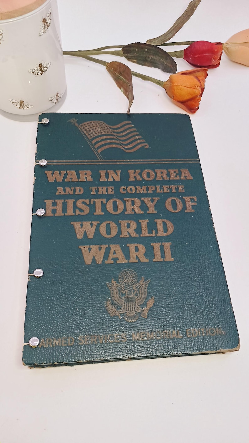 May include: A vintage book titled "War in Korea and the Complete History of World War II." The cover is dark teal with gold lettering and an American flag graphic. The book is an Armed Services Memorial Edition.