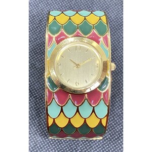 May include: A gold-tone wristwatch with a round face and a colorful, patterned band. The band features a repeating pattern of green, red, and yellow scales.