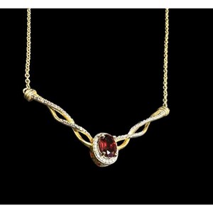 May include: A gold necklace with a twisted chain design features a red gemstone surrounded by a halo of smaller white gemstones.
