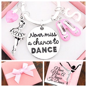 May include: A silver keyring with a charm that says "Never miss a chance to DANCE". The keyring also has a pink heart charm, a silver ballerina charm, and two pink ballet shoe charms.