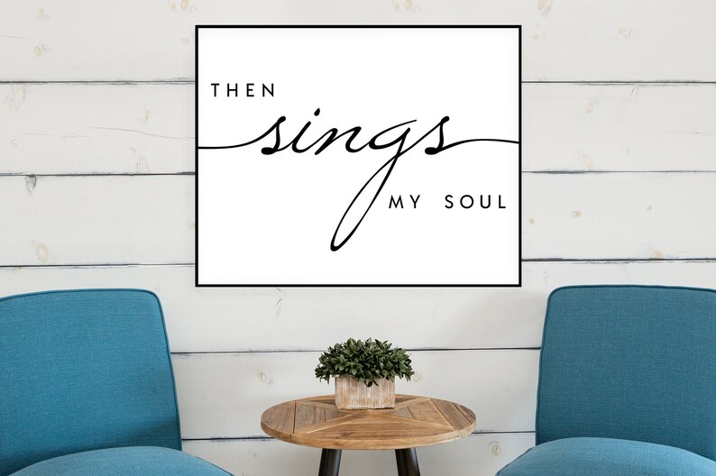 May include: A black and white print with the text "Then sings my soul" in a cursive font. The print is framed and hanging on a white wood wall.