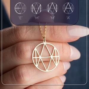 May include: A gold necklace with a circular pendant featuring a geometric design of overlapping triangles.