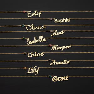 a collection of personalized name necklaces with gemstones, arranged in a row on a dark background.