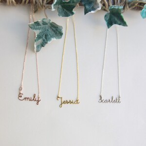 May include: Three delicate necklaces with personalized names, "Emily", "Jessica", and "Scarlett", in rose gold, gold, and silver.
