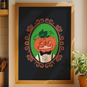 May include: A framed wall art print featuring a stylized orange jack-o'-lantern head with a green stem, wearing a black bow tie and white shirt with green suspenders, centered within an ornate brown oval frame against a solid black background.