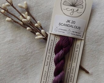 May include: A skein of JK 20 "Scandalous" stranded cotton thread, hand-dyed in Australia. The thread is a deep purple color and is 100% cotton. The label includes the text "Love the colour... feel the difference."