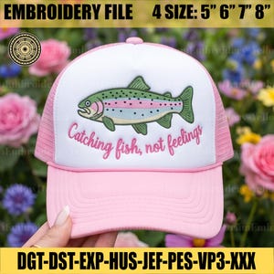 May include: Pink and white trucker hat with a green and pink fish embroidery. The hat features the text "Catching fish, not feelings." The embroidery file is available in 4 sizes: 5", 6", 7", and 8".