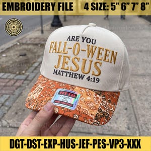 May include: A cream-colored baseball cap with an orange and white paisley patterned brim. The front features embroidered text reading ARE YOU FALL-O-WEEN JESUS MATTHEW 4:19 in black and gold. An OTTO brand sticker is attached to the brim.
