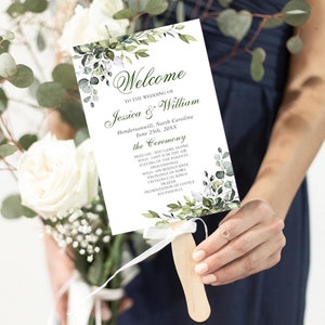 May include: A white wedding ceremony programme fan with green eucalyptus leaves and white flowers. The text reads "Welcome to the wedding of Jessica & William, Hendersonville, North Carolina, June 25th, 20XX, the Ceremony, Prelude - You Came Along, Solo - Love is in the Air, Seating of the Parents, Processional, Solo - On Bended Knee, Exchange of Vows, Exchange of Rings, Prayer, Presentation of Couple, Recessional."