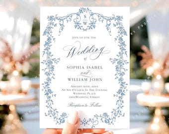 Op de afbeelding: Een witte huwelijksuitnodiging met blauwe bloemaccenten en elegant schrift. De uitnodiging bevat de namen Sophia Isabel en William John, samen met de trouwdatum, tijd en locatie. De tekst "Reception to Follow" is ook opgenomen.