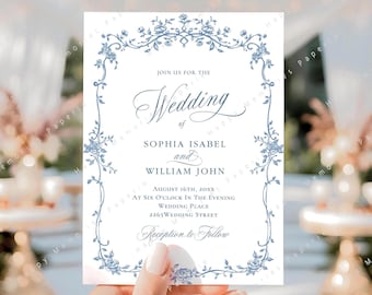Op de afbeelding: Een witte trouwuitnodiging met een blauwe bloemenrand. De tekst luidt "Join us for the Wedding of Sophia Isabel and William John", met datum en tijd. Het ontwerp is elegant en klassiek.