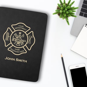 May include: Black leather folder with a gold firefighter emblem and the text "Your Department" and "Name Engraved Here". The folder also has the name "John Smith" printed on the front.