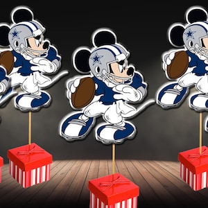 May include: Five red and white striped boxes with a blue and white football player Mickey Mouse topper on each. The Mickey Mouse figures are wearing a Dallas Cowboys helmet and jersey.