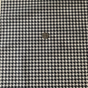 May include: Black and white houndstooth fabric with a small coin for scale.