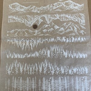 May include: White silhouette images of mountains and trees on a brown background. The images are arranged in rows, with the mountains at the top and the trees at the bottom. The text "白!HIOLP DISAR:林與味麵山B数深券遊" is printed at the top of the image.
