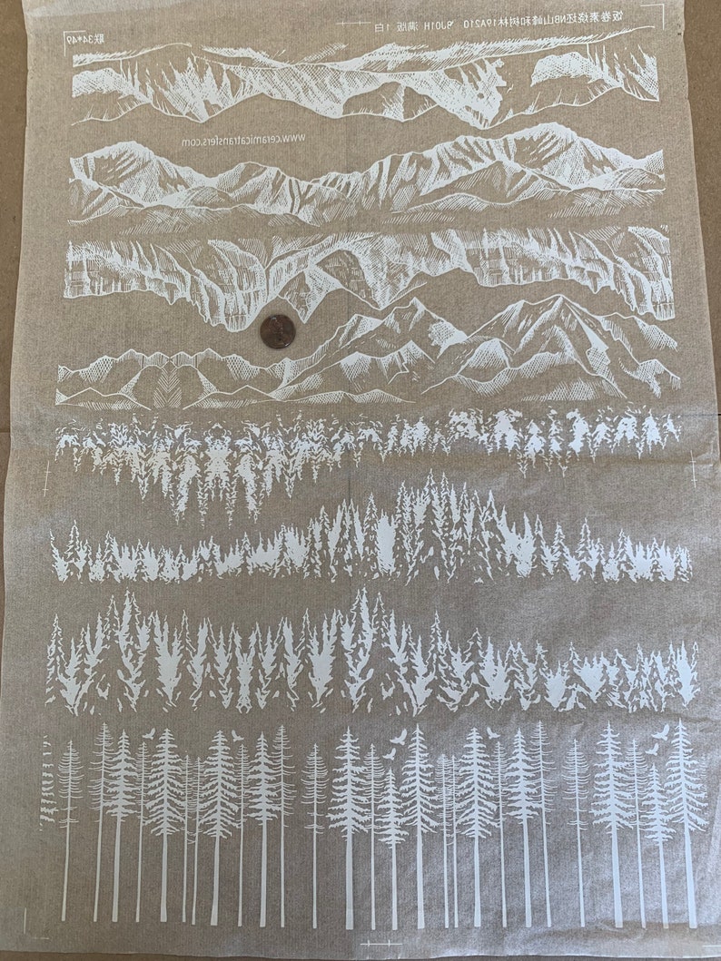 May include: White silhouette images of mountains and trees on a brown background. The images are arranged in rows, with the mountains at the top and the trees at the bottom. The text "白!HIOLP DISAR:林與味麵山B数深券遊" is printed at the top of the image.