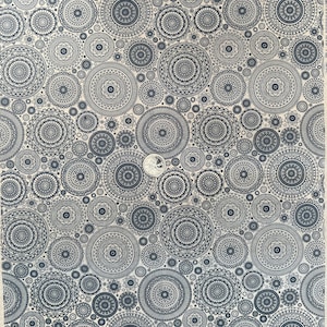 May include: A white background with a repeating pattern of black and gray mandala designs. The mandalas are of various sizes and have intricate details.