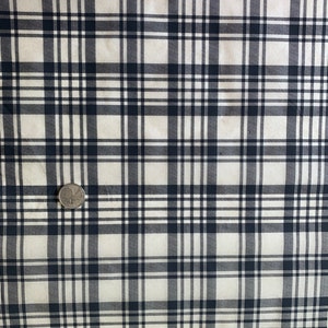 May include: White fabric with a black and white plaid pattern.