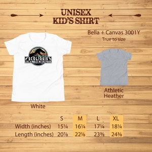May include: White unisex kid's t-shirt with a graphic of a dinosaur and the text "Scoliosis Like A Walk In The Park". The shirt is available in sizes S, M, L, and XL. The size chart shows the width and length of the shirt in inches.