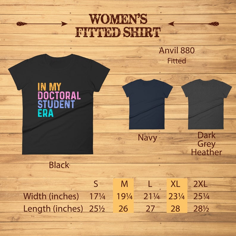 May include: A fitted black t-shirt with the text "In My Doctoral Student Era" in colorful letters. The shirt is available in sizes S, M, L, XL, and 2XL. The shirt is also available in navy and dark grey heather.