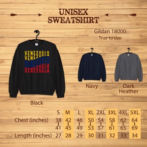 May include: Black unisex sweatshirt with the word "VENEZUELA" in yellow, blue, and red. The image shows the sweatshirt on a hanger, with navy and dark heather gray sweatshirts to the right. Chest sizes range from 38 to 64 inches, and lengths from 27 to 34 inches.