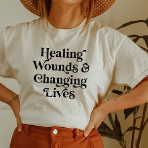 Wound care shirt, hoodie, sweatshirt, tank top, gift, Healing wounds and changing life, wound nurse, ostomy care, woc, nursing school