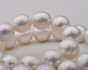 May include: A strand of white pearls, each pearl is round and smooth. The pearls are arranged in a circular pattern, with the ends of the strand overlapping.