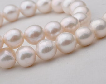 May include: A strand of white pearls, strung together in a classic necklace style.