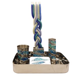 May include: A silver tray with a blue and green patterned design. The tray holds a braided candle, a small cup, and a small rectangular box, all with the same blue and green pattern.
