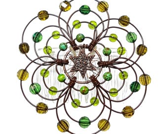 May include: A brown wire hair comb with green and brown beads in a circular design. The center of the comb features a star-shaped design.