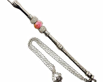 May include: A silver-toned pendant necklace featuring a hand gesture with an extended middle finger. The pendant has a decorative beaded section with a pink and white bead, and a silver chain.