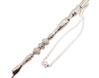 May include: Silver-toned pointer with a chain and a star of David charm. The pointer has a decorative handle and is adorned with clear and iridescent beads.