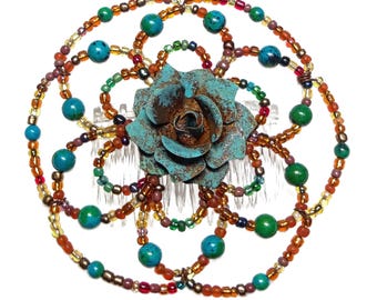 May include: A turquoise and copper flower hair comb with a beaded circle design in shades of brown, gold, green, and red.