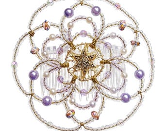 May include: A decorative hair comb featuring a floral design. The comb is adorned with clear and gold-colored beads, lavender and white pearls, and a gold-colored starburst centerpiece. The comb's teeth are clear.