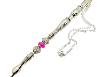 May include: A silver-toned metal pen with a chain and a star of David charm. The pen is decorated with a pink and clear crystal bead.