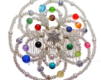 May include: A silver and white beaded hair comb with a star of David design and colorful beads. The comb is decorated with a variety of colors, including red, blue, green, yellow, and purple.