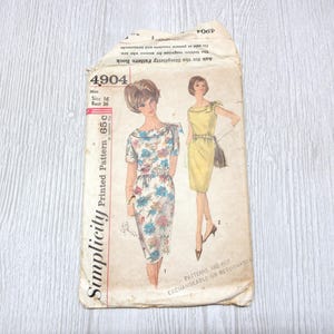 May include: A vintage Simplicity 4904 sewing pattern envelope for size 16, bust 36. The paper envelope features illustrations of two dress styles: one with a floral print and one in solid yellow. Text includes Simplicity, 4904, and 65c.