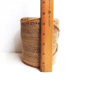 Natural burlap fabric roll, unused as originally bound. 5.5&quot; wide, unknown length.