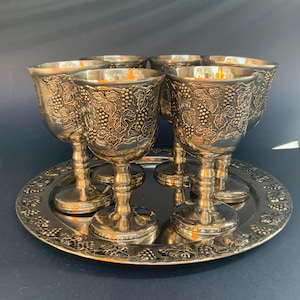 Antique metal goblets and tray decorated embossed with grapes and leaves Medieval wine glasses English Mid-century bar glass