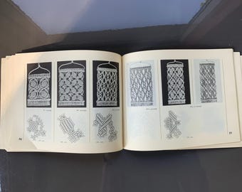 May include: A book with black and white illustrations of macrame wall hangings. The book has the page numbers 78 and 77 visible. The book is open to a page showing different macrame patterns.