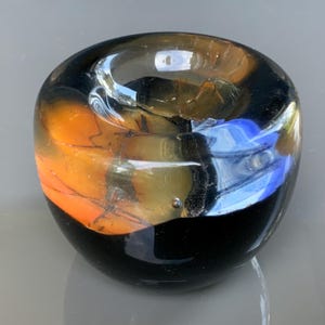 Lovely Glass Paperweight with a gold ornament In the middle of the center and blue stripes, and a Purple Glass base. Paperweight Glass decor