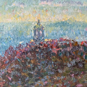 May include: A painting of a cityscape with a church steeple in the center. The sky is a light blue with hints of yellow and pink. The buildings are painted in shades of blue, purple, and brown.
