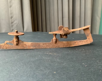 Vintage Metal Ice Skate: Rusty Industrial Winter Decor