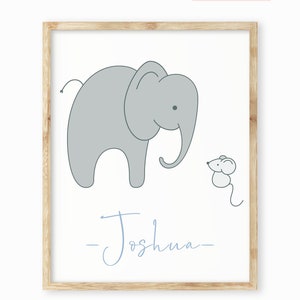 May include: A light blue framed print with a gray elephant and a small gray mouse. The text "Baba Snug" is in pink at the top of the print and the name "Joshua" is written in cursive at the bottom.