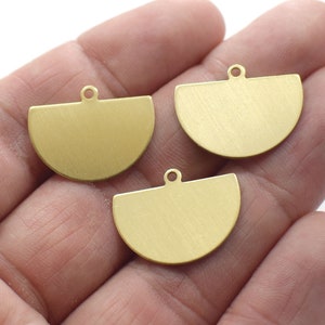 May include: Three gold-colored metal half-circle charms with a loop at the top for hanging.
